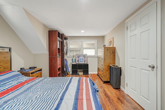 bedroom featuring baseboards and wood finished floors