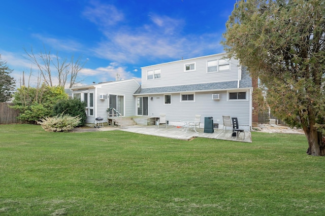 rear view of property featuring a wall unit AC, entry steps, fence, and a yard