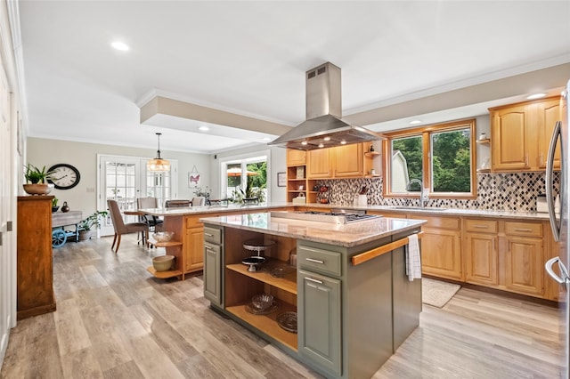 kitchen with stainless steel gas cooktop, open shelves, light wood-style flooring, island range hood, and a peninsula