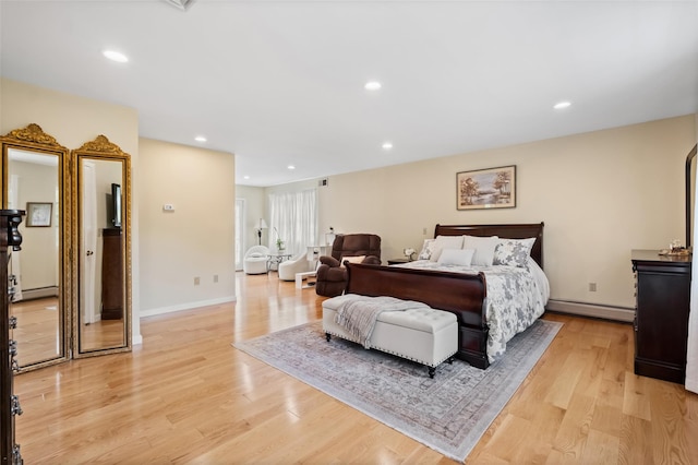 bedroom featuring a baseboard heating unit, recessed lighting, and light wood-style floors