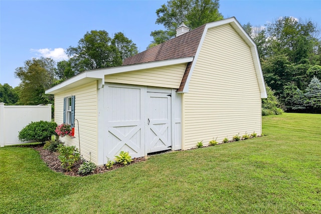 view of shed featuring fence