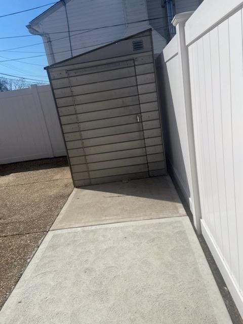 view of outbuilding featuring fence