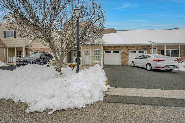 multi unit property featuring driveway and a garage