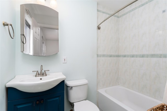 bathroom featuring shower / bath combination, vanity, and toilet