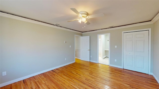 unfurnished bedroom featuring light wood-type flooring, visible vents, crown molding, and baseboards