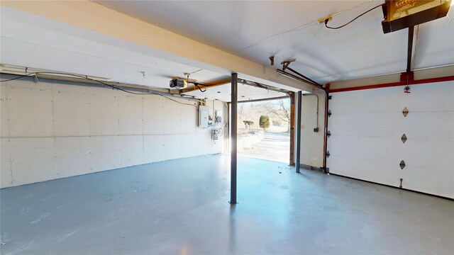 garage featuring a garage door opener and electric panel