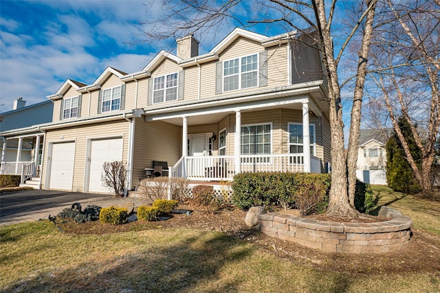 view of front of home with a garage, aphalt driveway, a chimney, and a porch