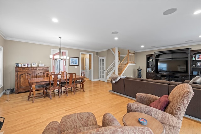 living area with crown molding, light wood finished floors, recessed lighting, an inviting chandelier, and stairs