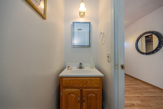 bathroom with wood finished floors and vanity