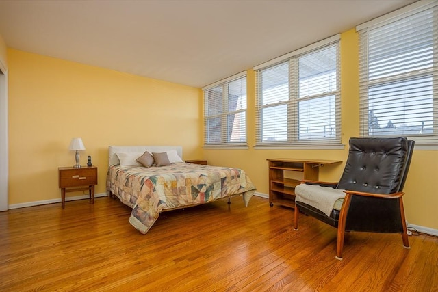 bedroom featuring light wood-style floors and baseboards