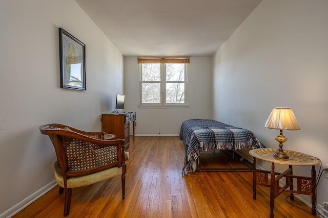 bedroom with baseboards and hardwood / wood-style floors