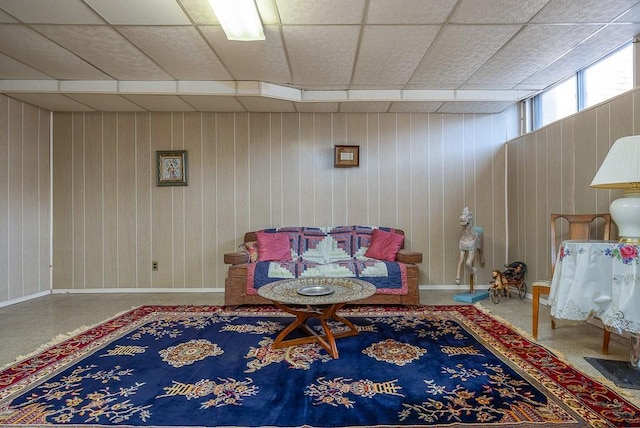 sitting room featuring a paneled ceiling and baseboards