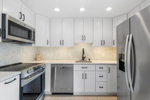 kitchen featuring a sink, light countertops, white cabinets, and stainless steel appliances