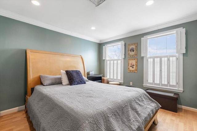 bedroom with recessed lighting, crown molding, baseboards, and wood finished floors