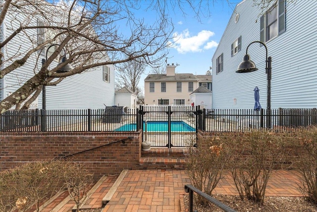 view of pool with a patio area, a fenced in pool, and fence