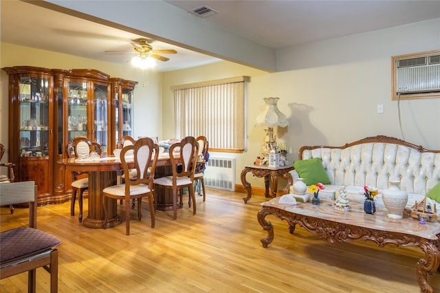 dining area featuring light wood-type flooring, radiator, visible vents, and a wall mounted AC