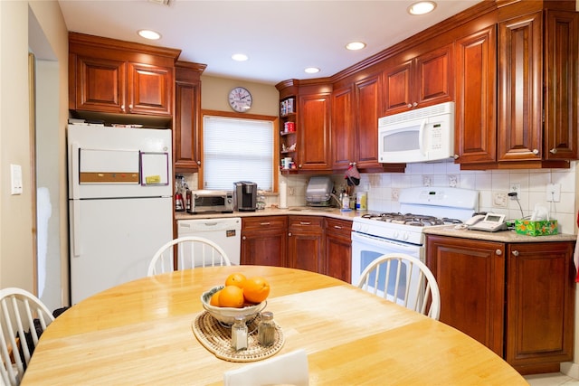 kitchen featuring white appliances, a toaster, backsplash, and recessed lighting