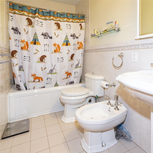 bathroom with toilet, tile patterned flooring, shower / bath combination with curtain, a bidet, and tile walls