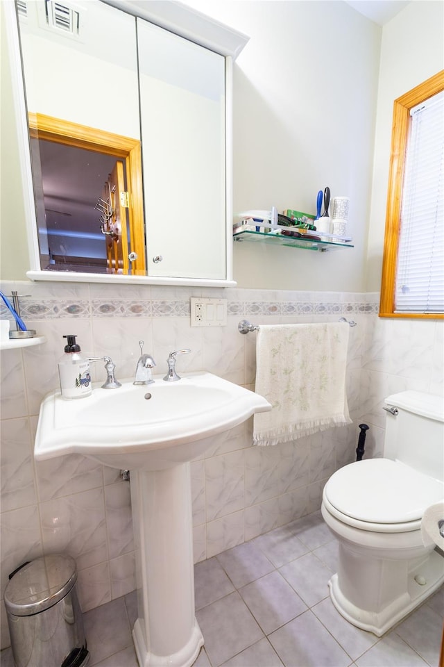 bathroom featuring toilet, tile patterned flooring, visible vents, and a sink