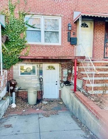 property entrance featuring brick siding