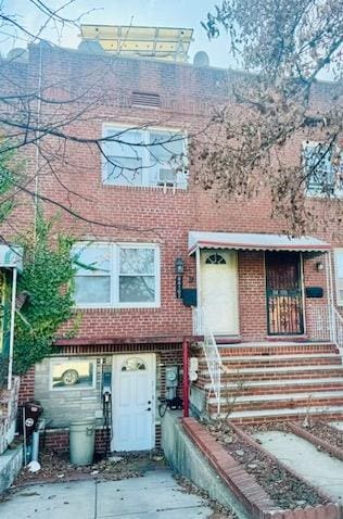 townhome / multi-family property with brick siding