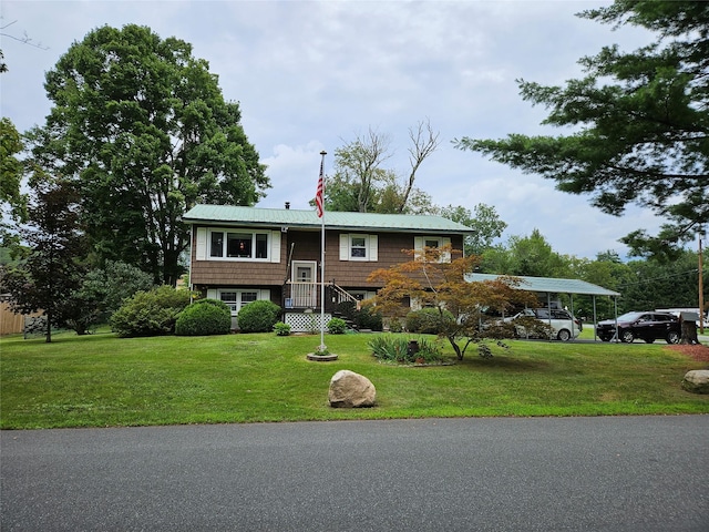 split foyer home with a front lawn and a carport