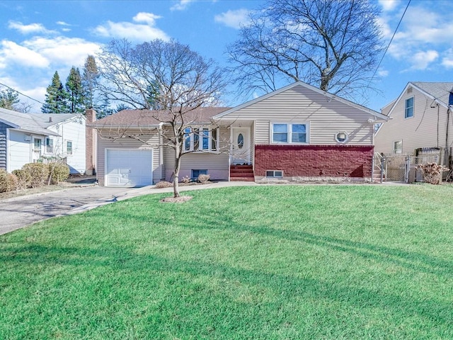 ranch-style home with driveway, an attached garage, a front lawn, and brick siding