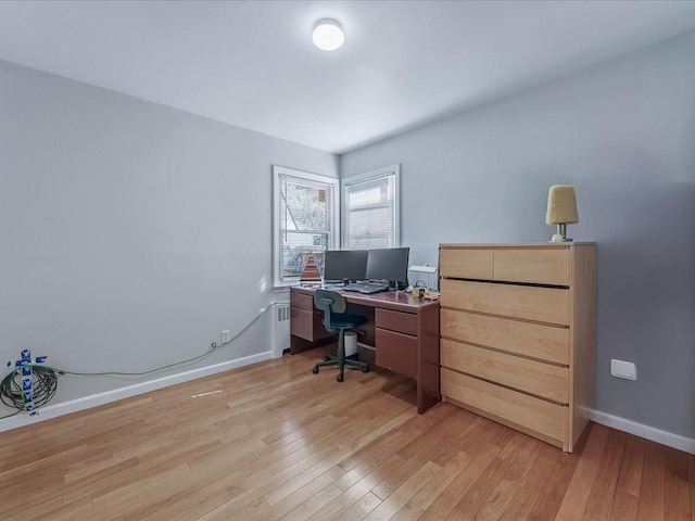 office area with baseboards and light wood finished floors