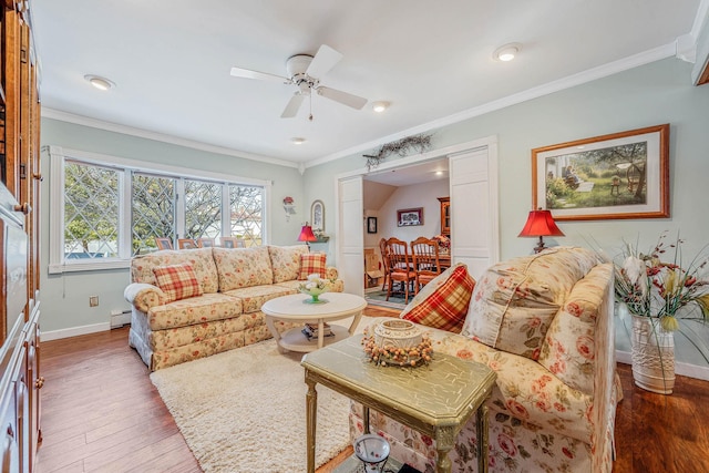 living area featuring baseboards, a ceiling fan, ornamental molding, wood finished floors, and baseboard heating