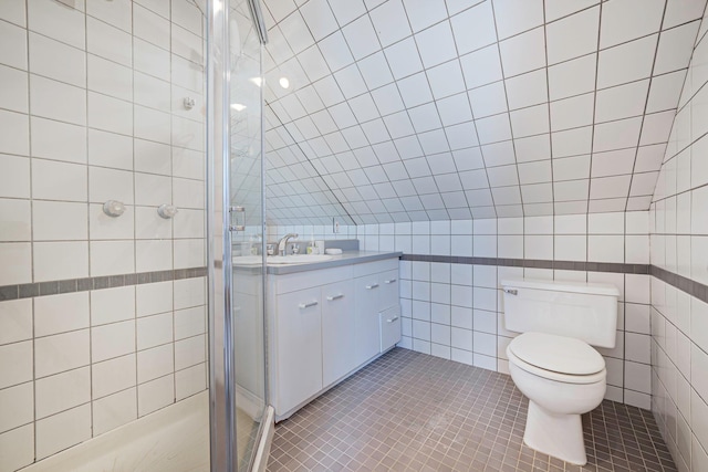 full bathroom with tile patterned flooring, toilet, vanity, tile walls, and a shower stall