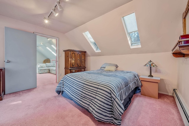 bedroom with lofted ceiling with skylight, a baseboard radiator, track lighting, and light colored carpet