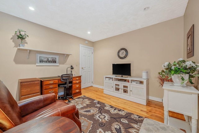 office space featuring light wood finished floors, recessed lighting, and baseboards