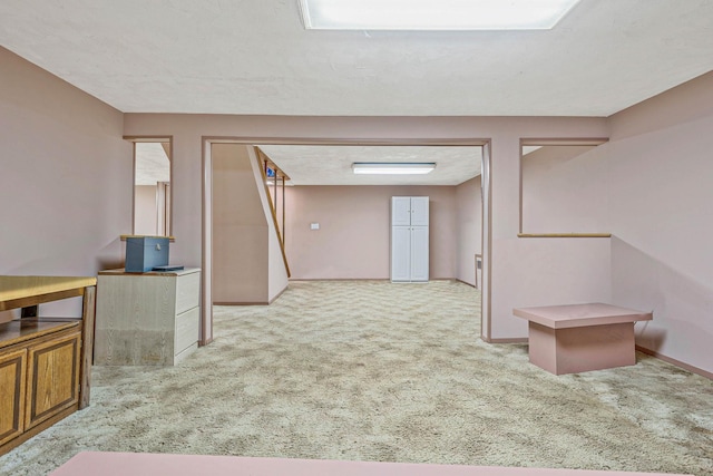 interior space with carpet floors and baseboards