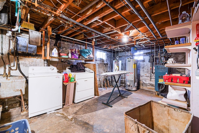 below grade area with water heater, a sink, and separate washer and dryer