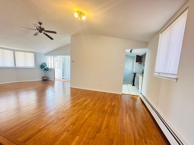 unfurnished living room featuring lofted ceiling, ceiling fan, baseboards, baseboard heating, and light wood-type flooring