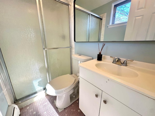 bathroom with toilet, a baseboard heating unit, a shower stall, vanity, and tile patterned floors