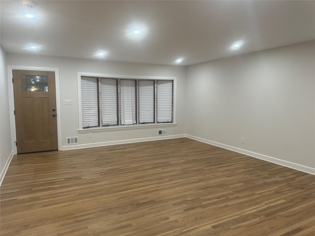 interior space with recessed lighting, wood finished floors, visible vents, and baseboards