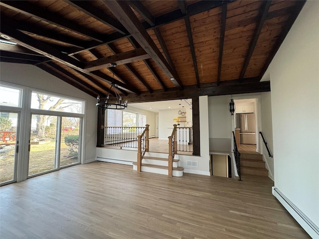 unfurnished living room featuring wooden ceiling, a baseboard heating unit, and wood finished floors