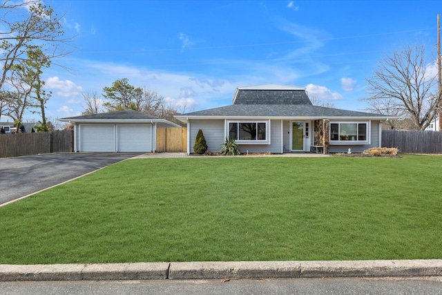 view of front of property with an outdoor structure, a garage, fence, and a front lawn