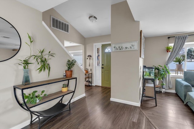 foyer entrance with stairway, wood finished floors, visible vents, baseboards, and lofted ceiling