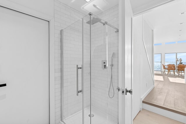 bathroom featuring wood finished floors and a stall shower