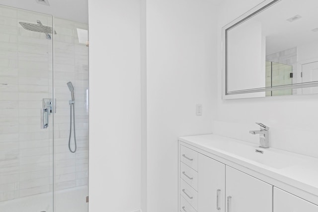 bathroom featuring visible vents, a stall shower, and vanity