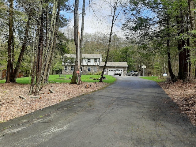 view of front of house with a front yard and stone siding