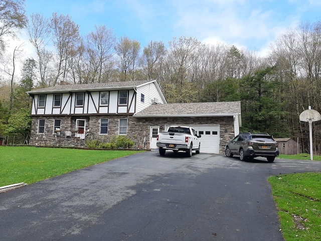 view of front facade featuring driveway, a garage, a chimney, a front yard, and stucco siding