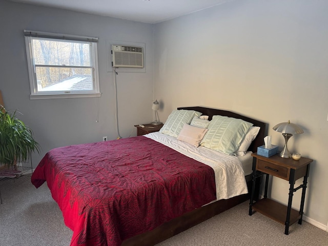 bedroom featuring baseboards, an AC wall unit, and carpet flooring