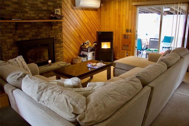 carpeted living area featuring a wall unit AC, a brick fireplace, and wood walls