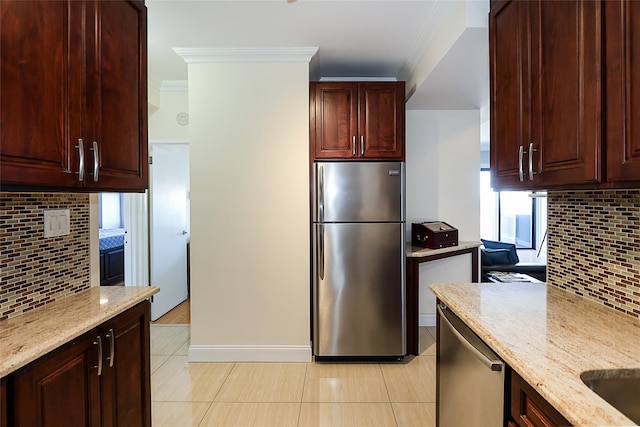 kitchen featuring ornamental molding, stainless steel appliances, light stone counters, and decorative backsplash