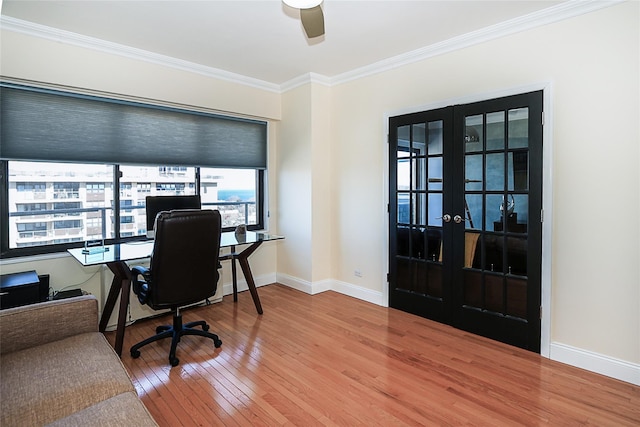 home office with baseboards, ceiling fan, hardwood / wood-style floors, crown molding, and french doors