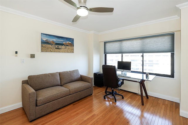 office area featuring baseboards, a ceiling fan, light wood-style flooring, and crown molding