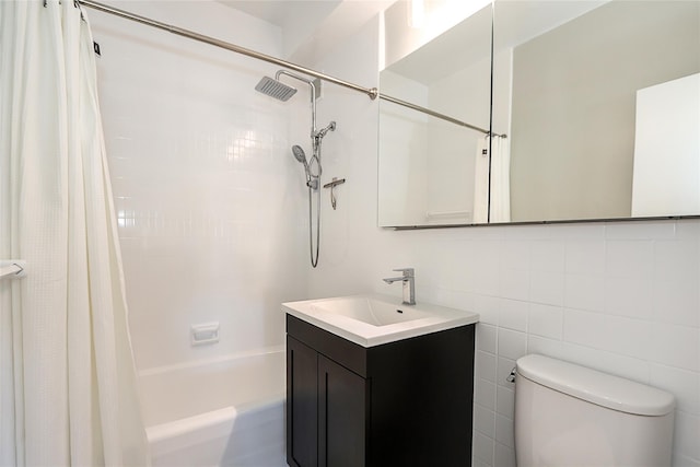 bathroom featuring tile walls, vanity, toilet, and shower / tub combo with curtain